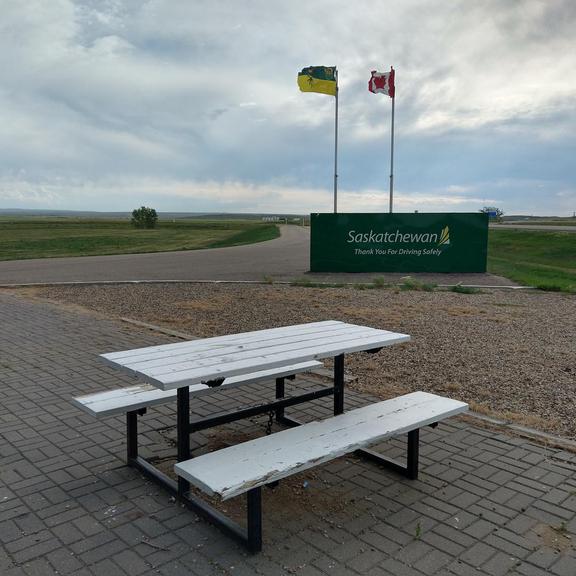 Picnic table and Saskatchewan sign at Cummings Rest Area