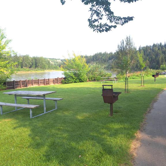 Picnic tables and wood grills at Devon Lions Campground