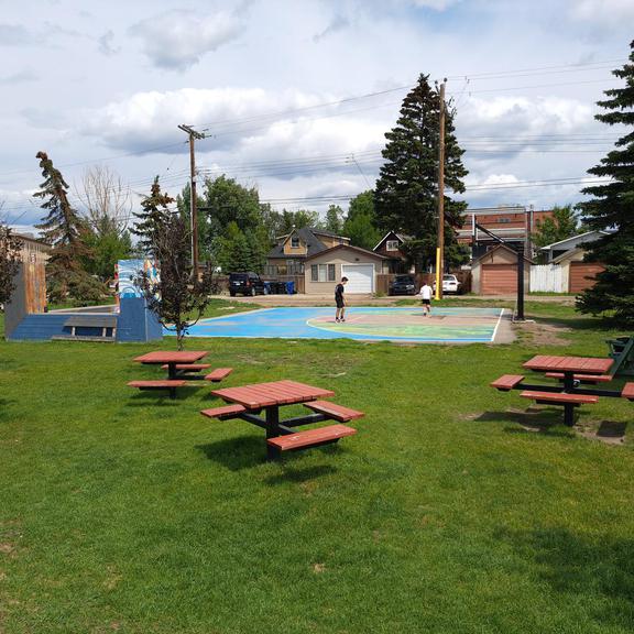 Picnic tables and a basketball court at Gopher Park in Calgary Alberta