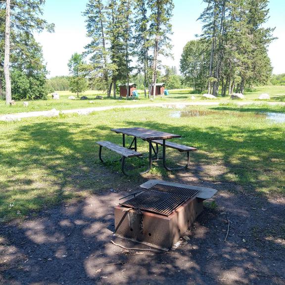 Picnic table and fire pit at the old Pinawa dam
