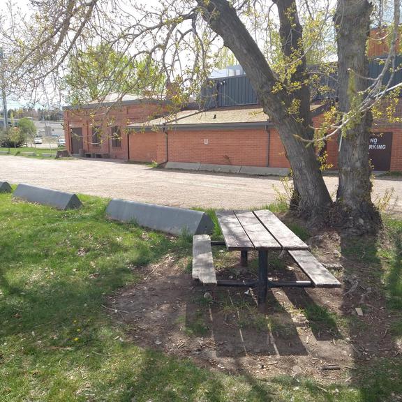 Picnic table at Pumphouse Park, with the theatre in the background