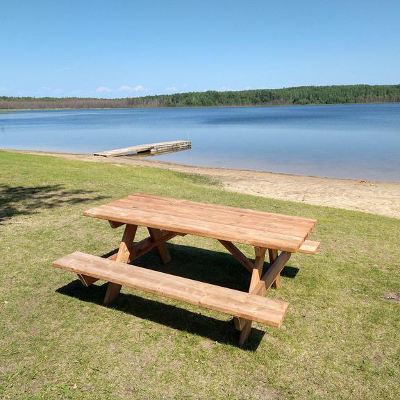 Picnic table, beach, and lake at Clear Lake Park