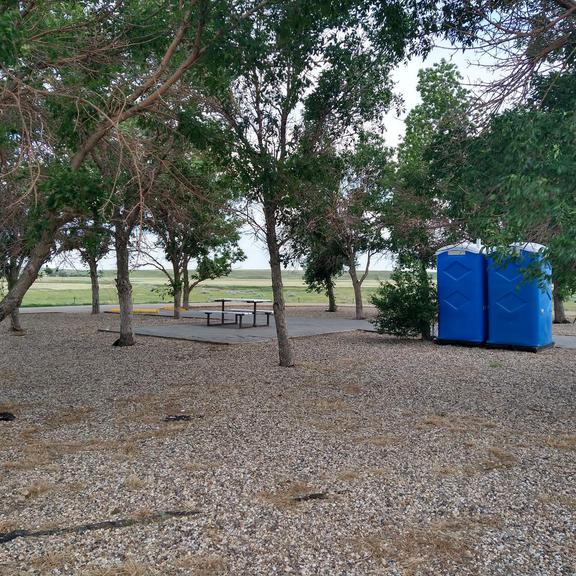 Picnic table and portable toilets at the Cummings Rest Area