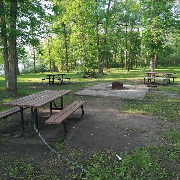 Picnic tables and fire pit at Whitemouth Falls Provincial Park