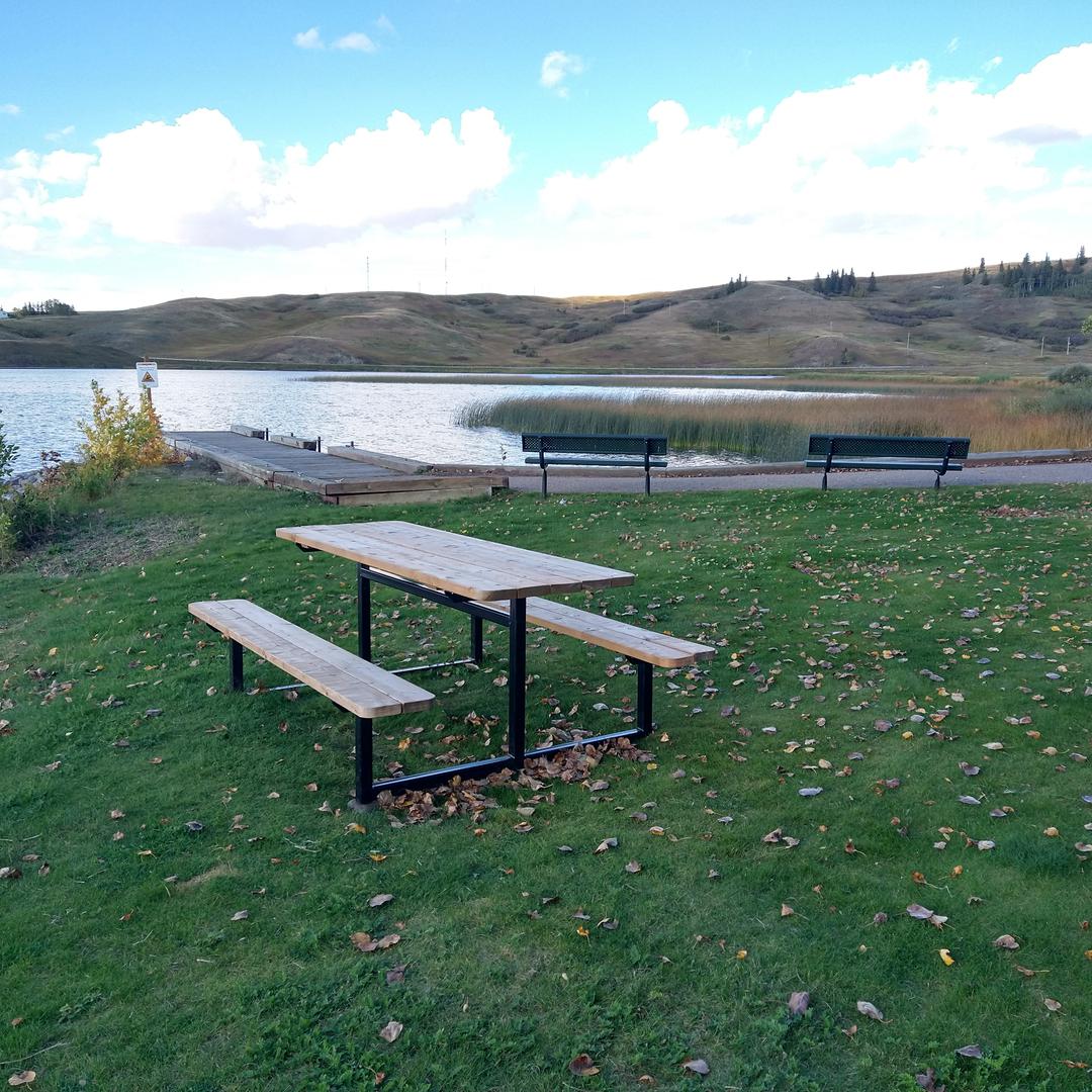 Picnic tables and benches at Elkwater Beach in Cypress Hills Provincial Park